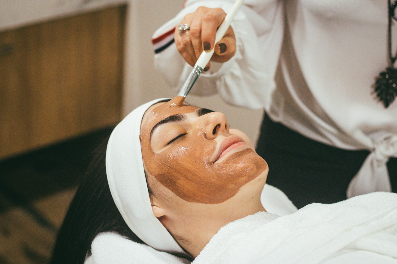 A facial being applied to a client